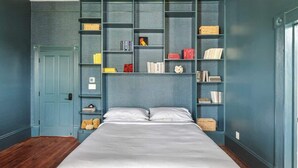 Un dormitorio con una cama grande, una estantería empotrada y una puerta.
