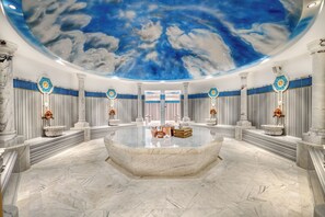 A luxurious bathroom with a marble floor, a central sink, and a ceiling with a starry sky mural. - BN Hotel Thermal & Wellness (Mersin)