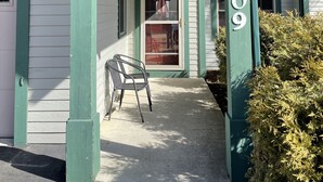 A house with a covered porch, a visible door, and the number 8409 on the right side.
