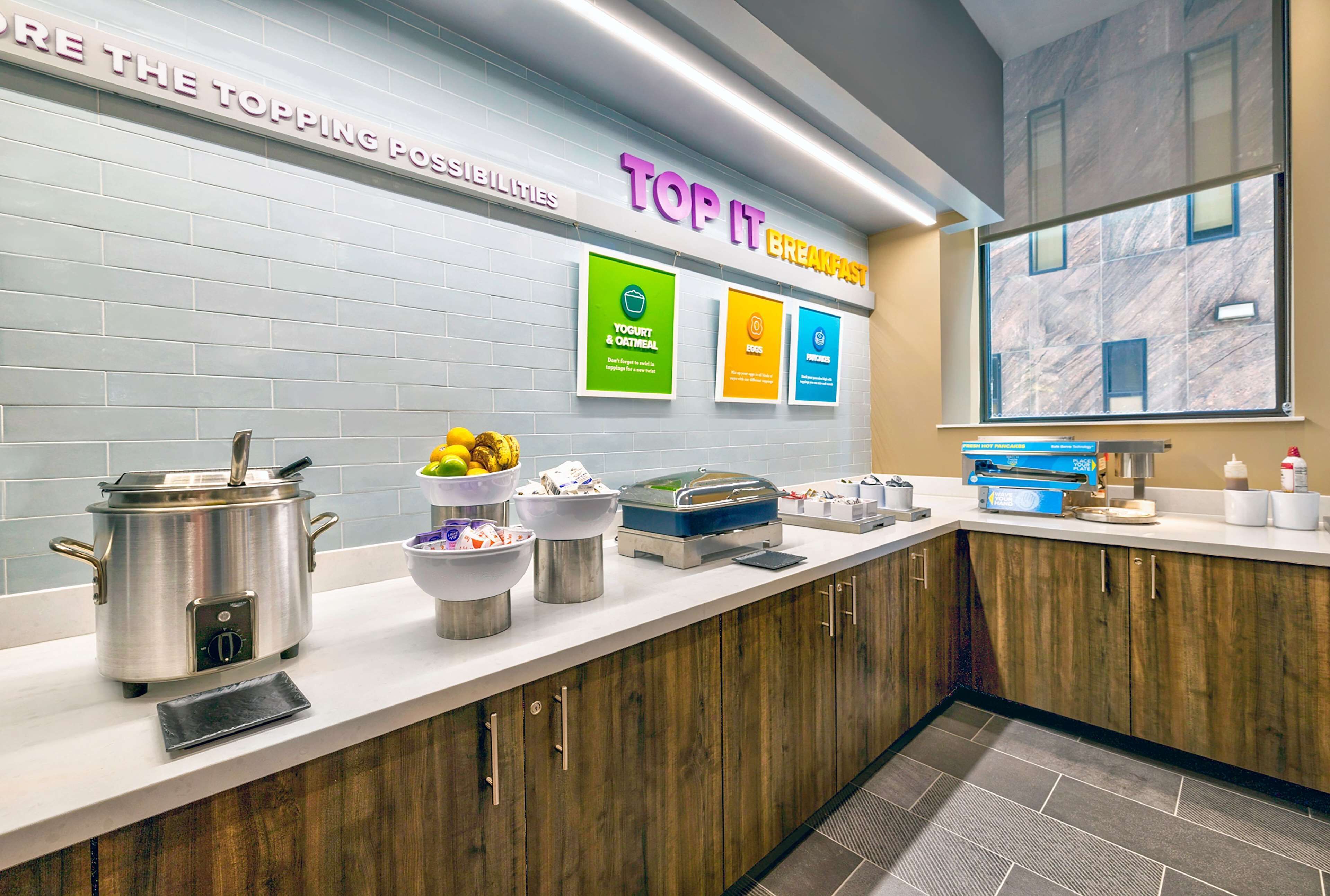 A breakfast station with yogurt and oatmeal, free Wi-Fi, and a coffee machine.
