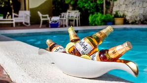 A poolside setting with a bowl containing several bottles of beer. - Beauty Bavaro Playa Matilde (Punta Cana)