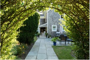 Stroll through the beautifully maintained garden to the traditional house with a welcoming front porch.