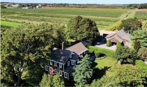 Set amidst lush greenery and expansive fields, this house offers a peaceful retreat.