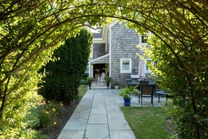 Stroll through the beautifully maintained garden to the traditional house with a welcoming front porch.