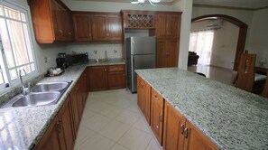 Fridge, stovetop, cookware/dishes/utensils, dining tables