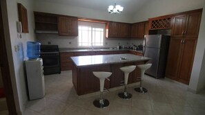 Fridge, stovetop, cookware/dishes/utensils, dining tables