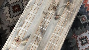 A wooden board game with holes and lines, labeled "Little Bass Lake." - Little Bass Cabin - Kayaks & Clear Water Swimming (Grand Rapids)