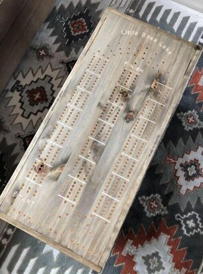 A wooden board game with holes and lines, labeled "Little Bass Lake." - Little Bass Cabin - Kayaks & Clear Water Swimming (Grand Rapids)