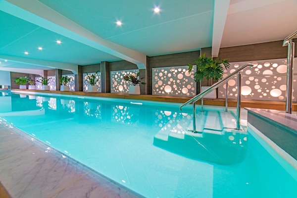 Indoor pool, open 8:00 AM to 10:00 PM, pool loungers