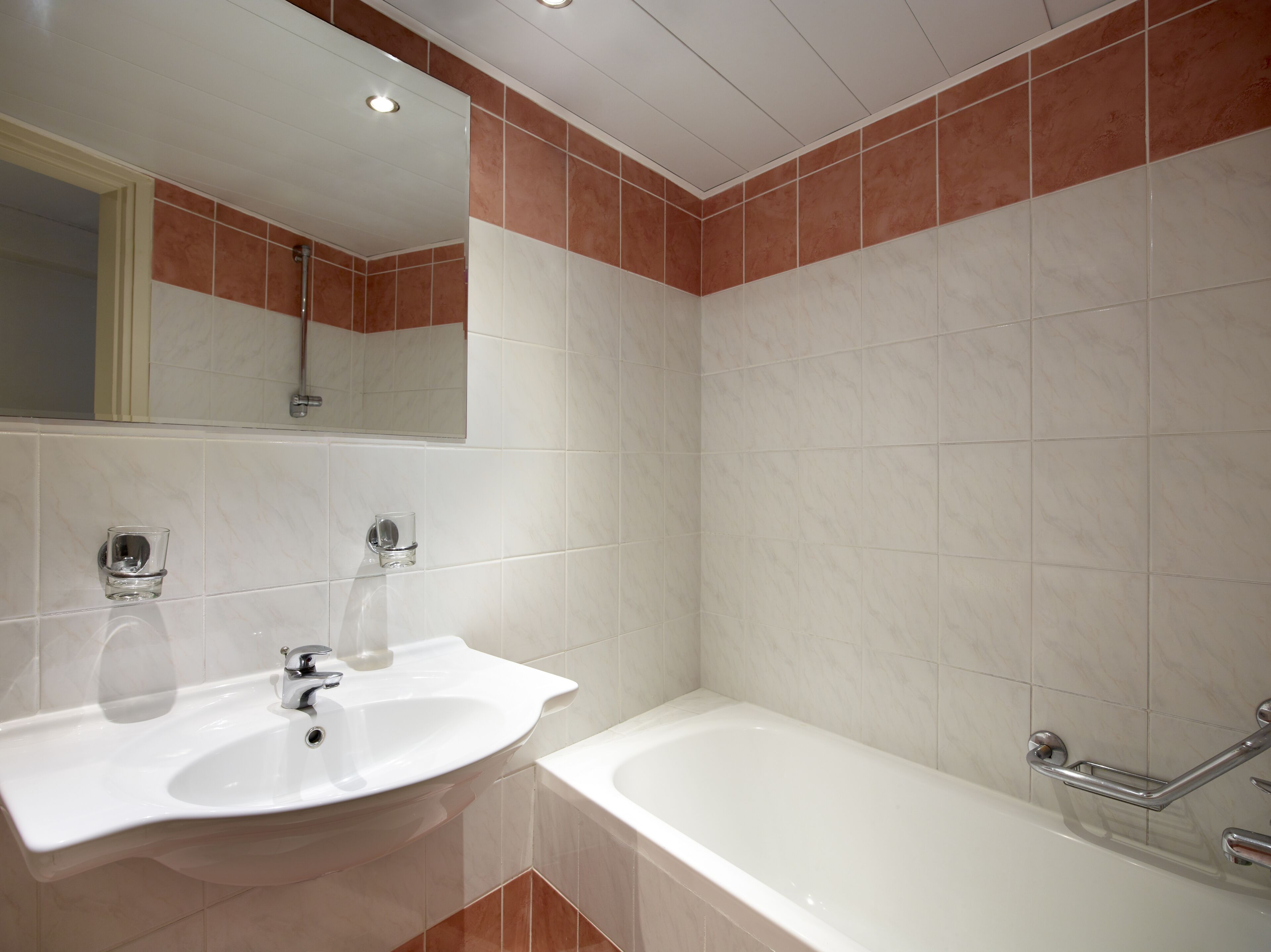 bathtub, hair dryer, towels, soap