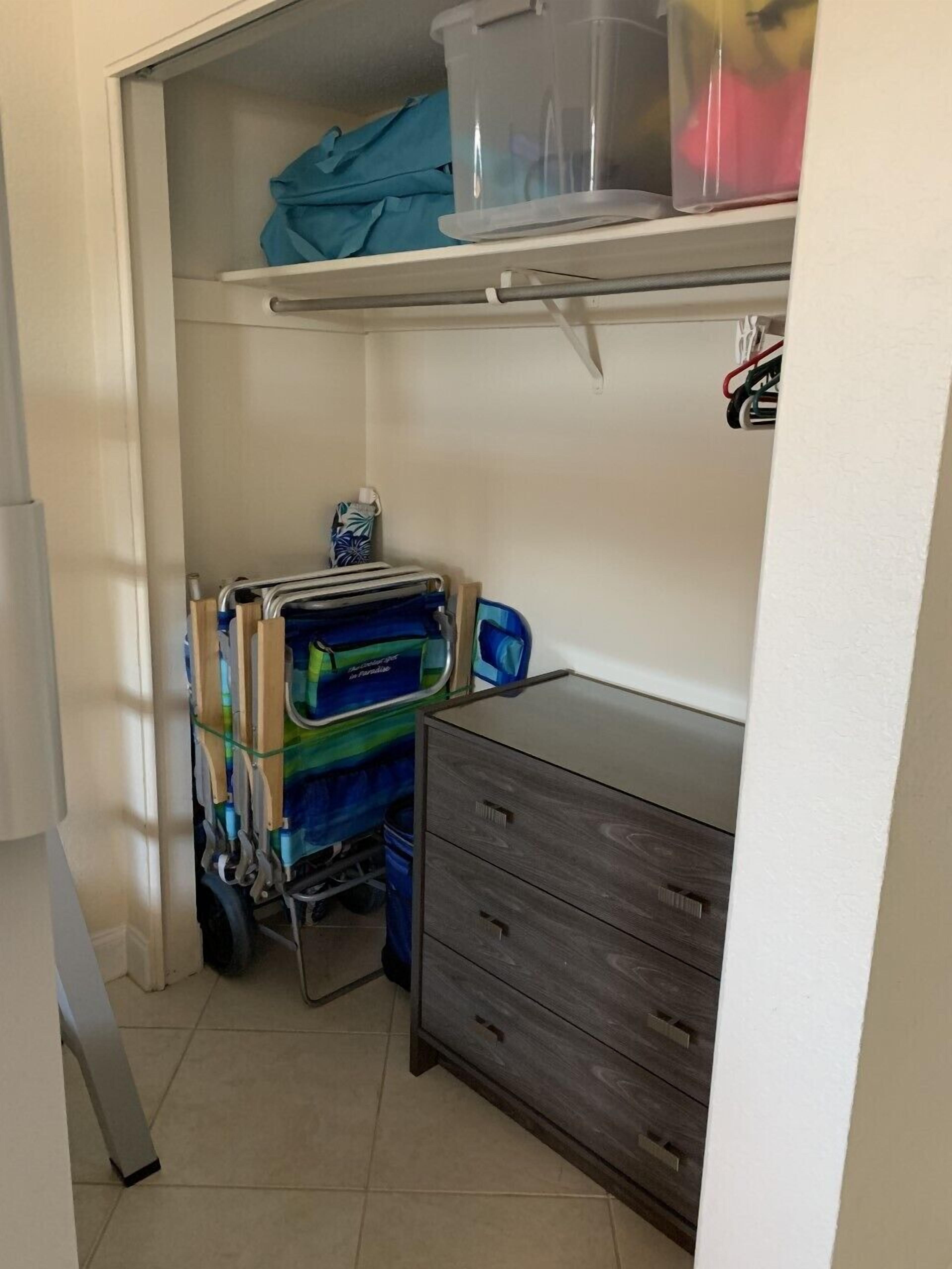 A compact storage area with a wooden cabinet and a shelving unit.