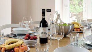 A dining table set with plates of fruit, a bottle of wine, and various glasses. - PRIVATE POOL - AGRITURISMO FATTORIA LA PIEVE - VILLA NERINO 8 km from Pisa  (Calci)