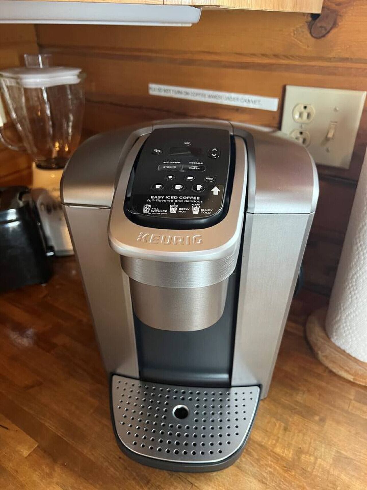 A Keurig coffee maker with a control panel and a drip tray.