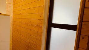 A hallway with wooden paneling and a white door with frosted glass panels. - Luxurious villa in cap d'agde  (Agde)