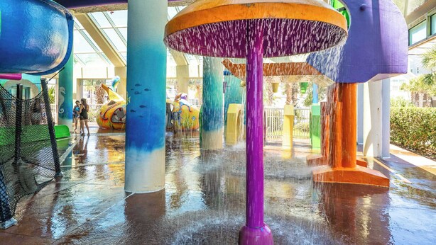A water feature with multiple colorful columns and a central structure. - Beachfront condo with pools & hot tub (Myrtle Beach)