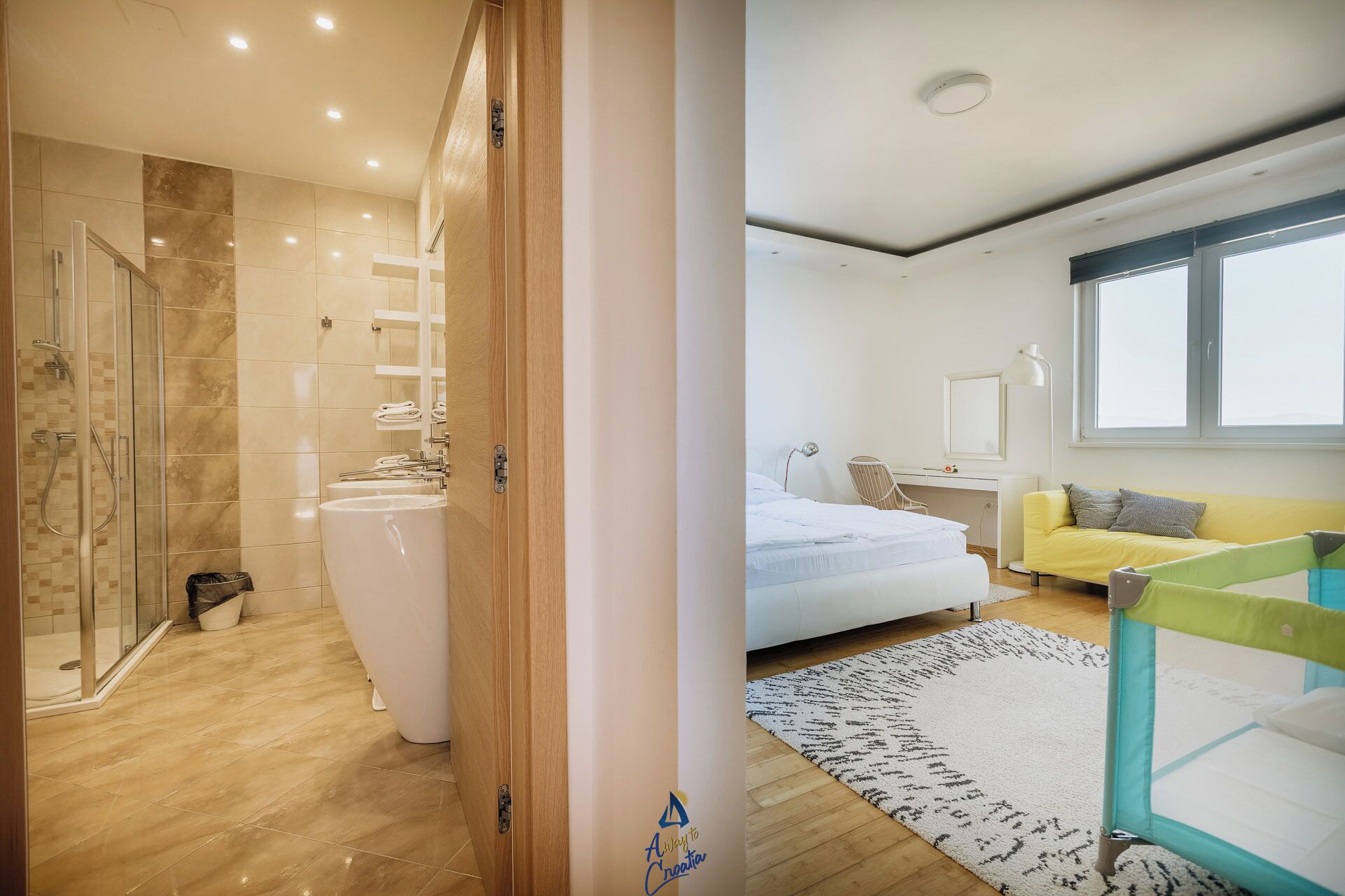 A modern bathroom with a shower, sink, and toilet.