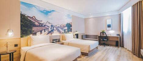 A hotel room with two beds, a desk, a chair, a lamp, and a large wall mural.