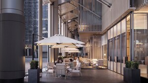 An outdoor seating area with tables and chairs, large umbrellas, and potted plants. - Intercontinental Xi an North (Xi'an)