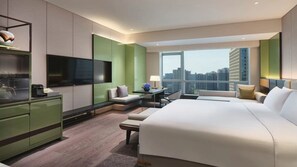 A modern hotel room with a large bed, a desk, a flat-screen TV, and a city view. - Intercontinental Xi an North (Xi'an)
