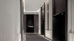 A modern hallway with a polished floor, recessed lighting, and a central elevator. - Intercontinental Xi an North (Xi'an)