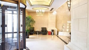 A lobby with a grand chandelier, a reception desk, and a staircase. - Friend Hotel Shanghai (Shanghai)