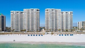 A beachfront hotel with multiple high-rise buildings, a sandy beach, and clear blue water. - 2026 Updated, 5-Star, Modern Beachfront Condo at Silver Beach Towers (Destin)
