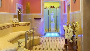 A hotel lobby with a patterned floor, a reception desk, and a statue in the background. - Centralni Lazne Ensana Health Spa Hotel (Marianske Lazne)
