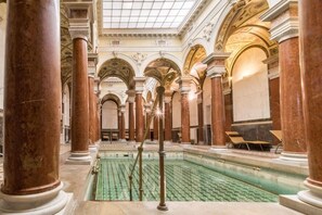 A grand hall with marble columns, a central pool, and ornate ceiling details. - Centralni Lazne Ensana Health Spa Hotel (Marianske Lazne)