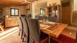 A dining area with a wooden table, chairs, and a ceiling fan. - Son Bordoi by Interhome (Moscari)