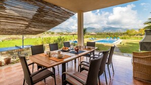 An outdoor dining area with a view of a swimming pool and mountains. - Son Bordoi by Interhome (Moscari)
