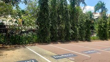 A parking lot with spaces marked for Hudson Apartments Hotel.