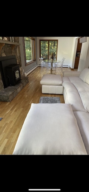 Cozy up by the fireplace and enjoy the view from the large windows in this inviting living area.