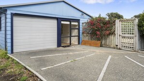A single-story building with a closed garage door and a small entrance.