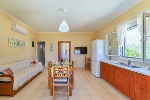 Enjoy meals in the dining area with a table set for two and a comfortable bench.