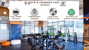 A gym with weightlifting equipment and dumbbells, a registration desk, and a swimming pool. - Hoasun Skyview Sunwah Pearl (Ho Chi Minh City)