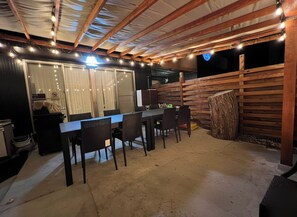 An outdoor patio with a dining table and chairs, surrounded by wooden walls and a ceiling with exposed beams. - Diamond YU (Fujikawaguchiko)