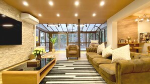 A modern living room with a sofa, armchairs, a coffee table, and a TV. - Diamond YU (Fujikawaguchiko)