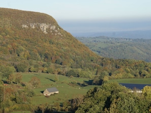 Escape to a serene rural haven surrounded by rolling hills and lush greenery.