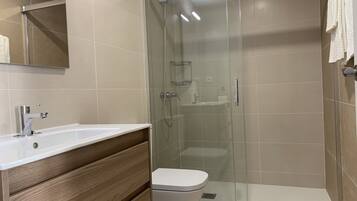 Shower, hair dryer, towels, toilet paper