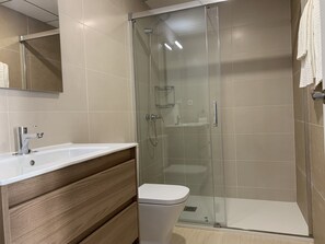 Regadera, secadora de cabello, toallas, papel de baño