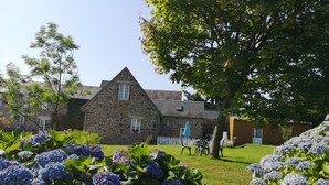 A stone building with a triangular roof, a white picket fence, and a lawn with hydrangea flowers. - Cottage 2 to 7 people between the sea and the countryside (Folligny)