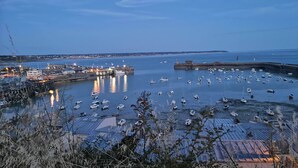 A harbor with numerous boats docked, a pier, and buildings in the background. - Cottage 2 to 7 people between the sea and the countryside (Folligny)