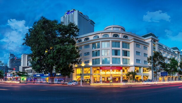 A hotel with a prominent sign, multiple floors, and a modern architectural style. - Tran Vien Dong Hotel (Nha Trang)