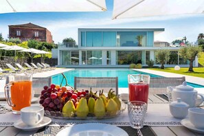 Enjoy a leisurely morning by the pool with a delicious breakfast spread.