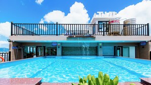 A swimming pool with a view of the sea, a balcony with a railing, and a sign for 'DAPH' on the building. - Tuan Ninh Hotel 2  (Ho Chi Minh City)