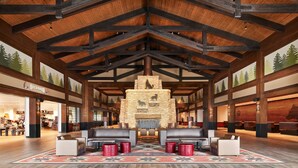 A spacious lobby with a high wooden ceiling, a stone fireplace, and leather seating areas. - Great Wolf Lodge Manteca (Manteca)