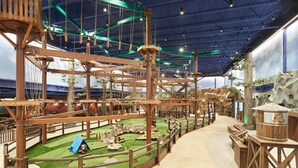 An indoor adventure park with rope bridges, climbing structures, and a small play area. - Great Wolf Lodge Manteca (Manteca)