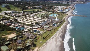 An aerial view of a coastal resort with multiple buildings, a beach, and a golf course. - B&B Villa Maria Guest Rooms - San Roque Golf - Sotogrande (San Roque)