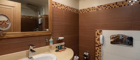 A modern bathroom with a large sink, a mirror, and a telephone.