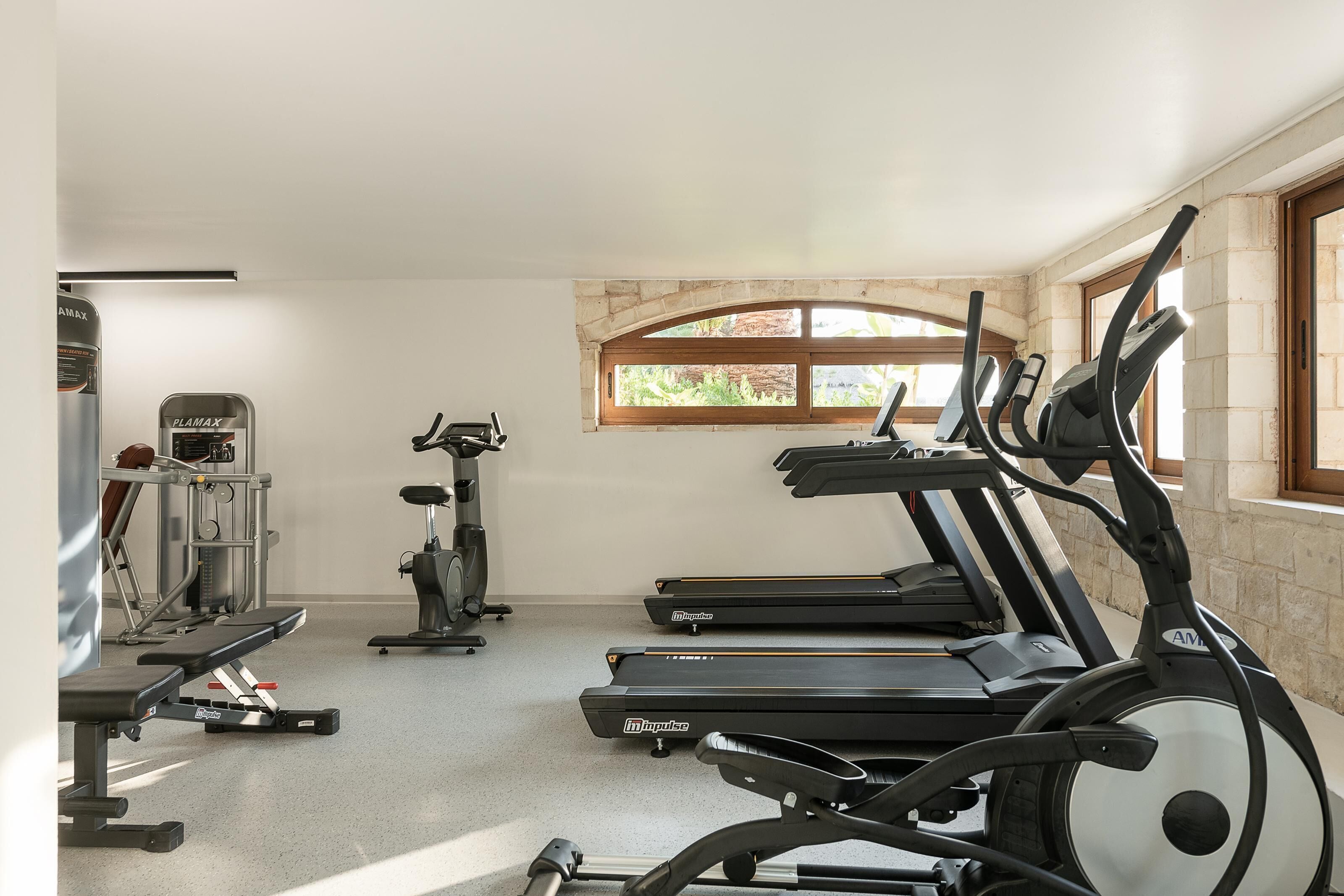 A gym with treadmills, a stationary bike, and weight machines.